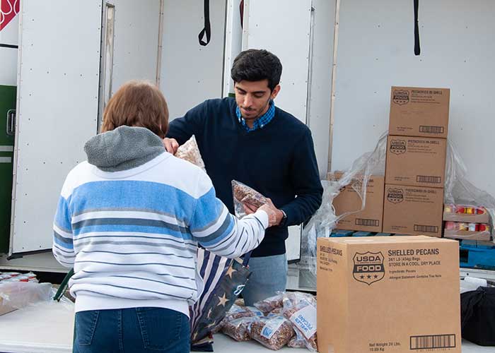 Volunteer handing out food at food pantry